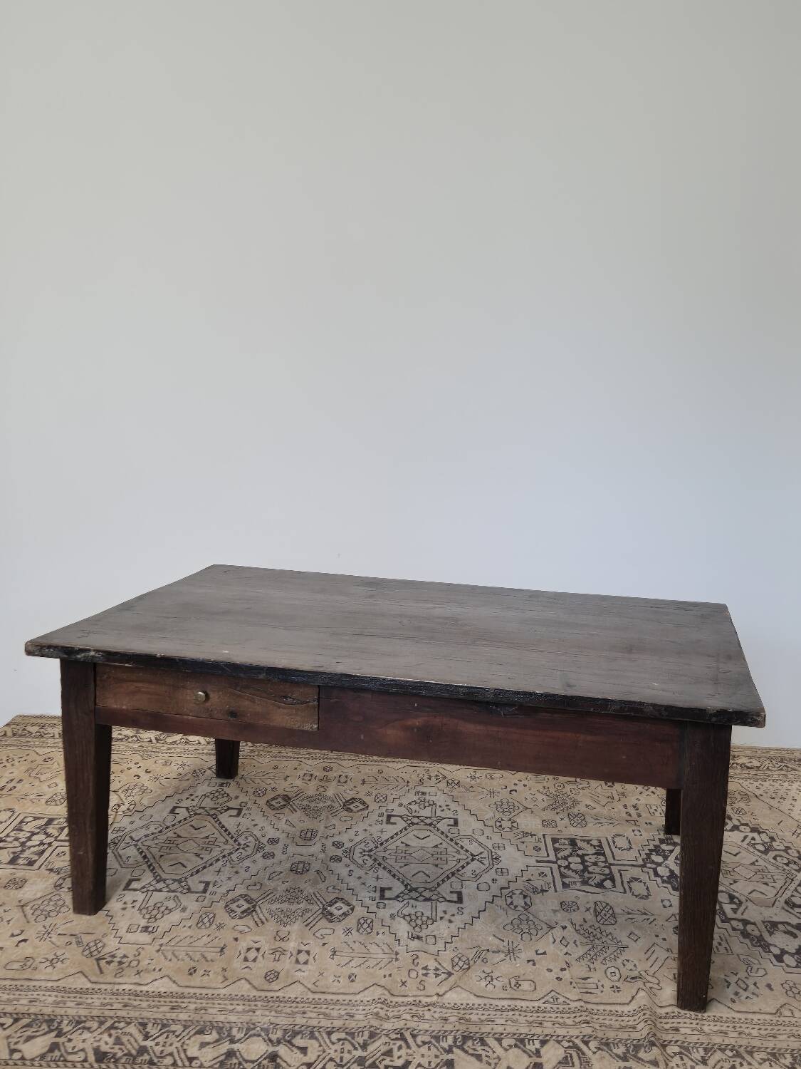 Rustic farmhouse coffee table from the 1900s with two drawers.