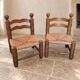 Pair of low fireplace chairs in turned wood and straw, Charles style.