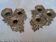 Pair of antique candlesticks with a floral design.