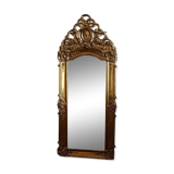 Large antique baroque mirror with angel decorations.