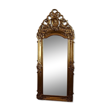 Large antique baroque mirror with angel decorations.