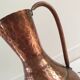 Pitcher-shaped vase in hammered copper
