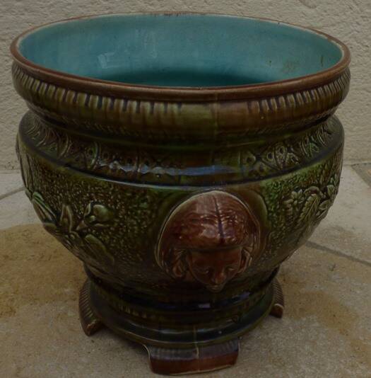 Old earthenware cachepot with woman decoration