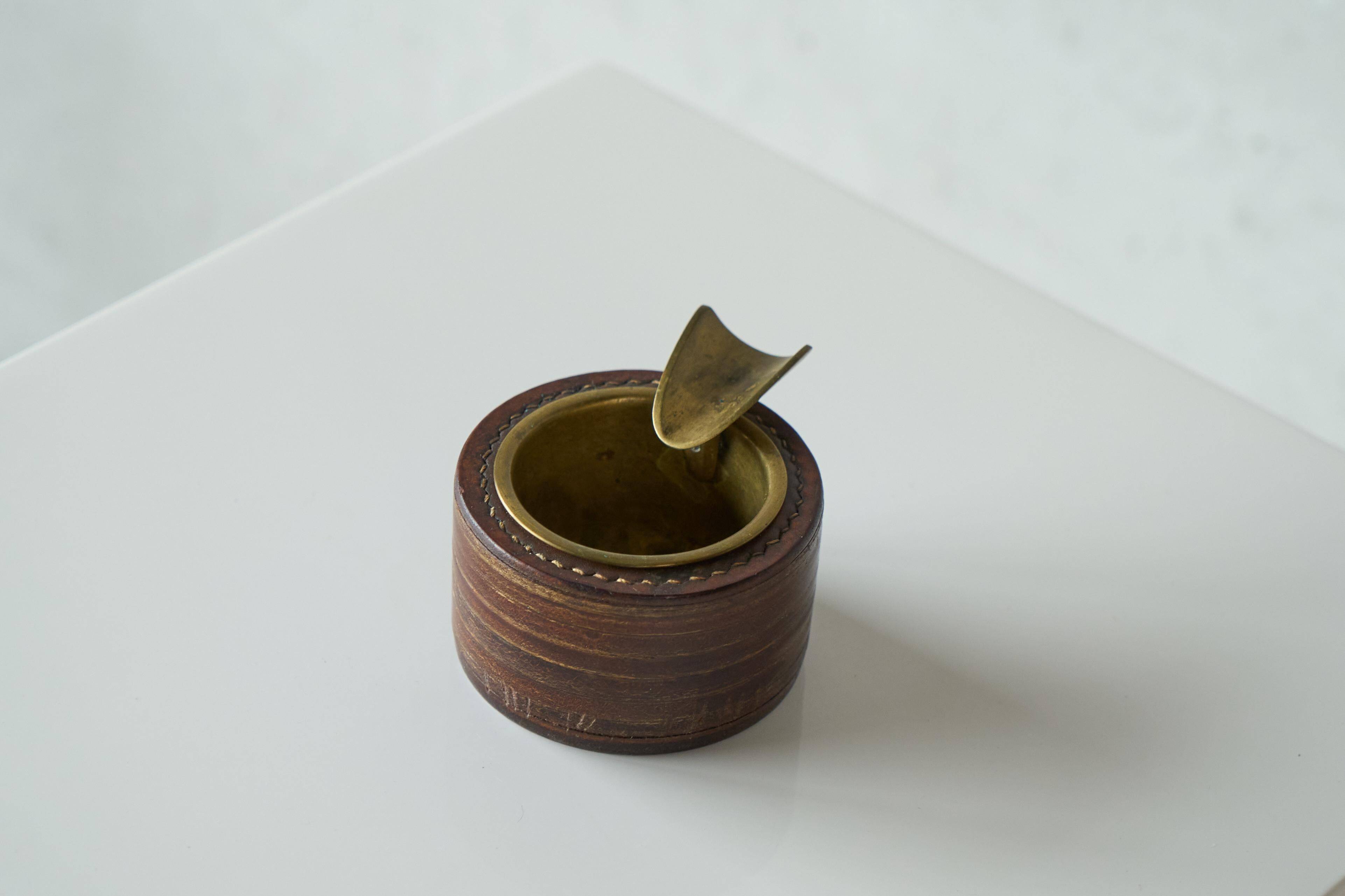 Vintage leather and patinated brass ashtray, 1960s, mid-century design.