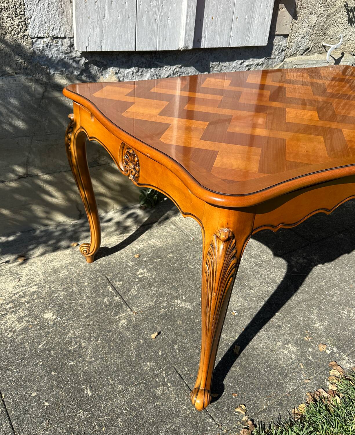 Antique extendable table in cherry wood and marquetry in the Louis XV style.