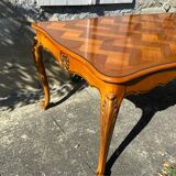 Antique extendable table in cherry wood and marquetry in the Louis XV style.