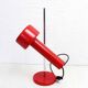 Red metal articulated desk lamp