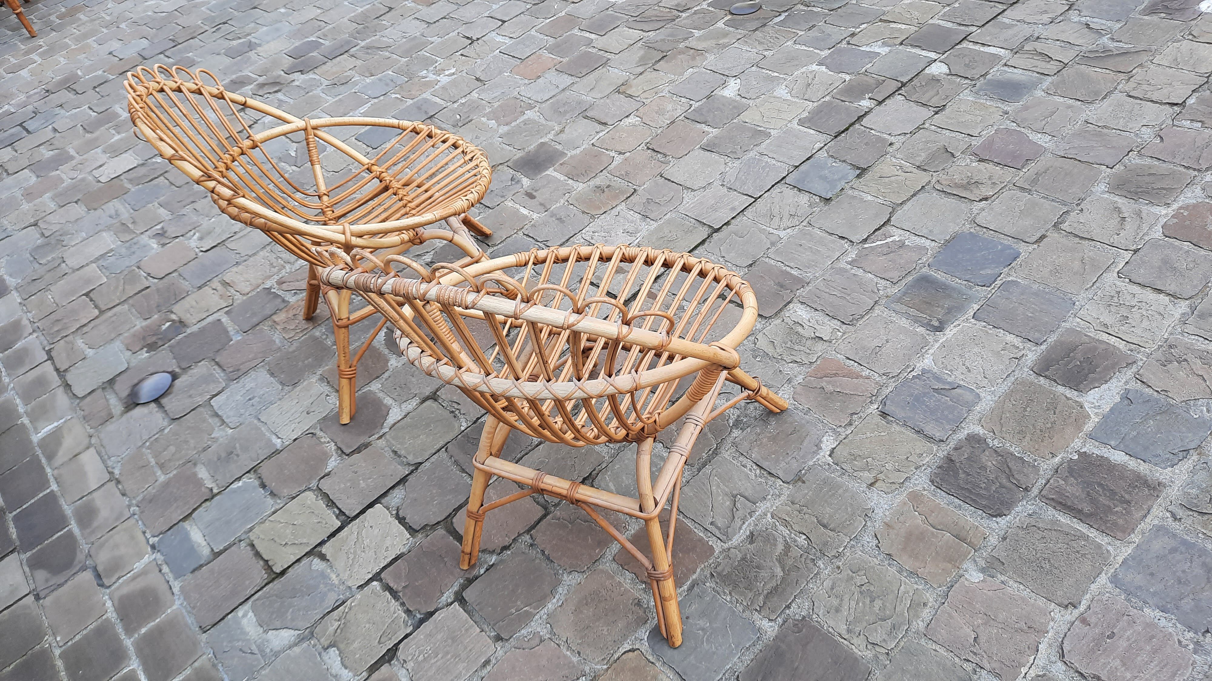Pairs of shell rattan armchairs from the 50