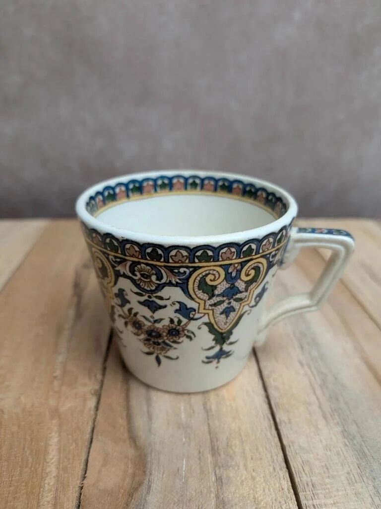 Antique ironstone cup from Sarreguemines with polychrome decoration.