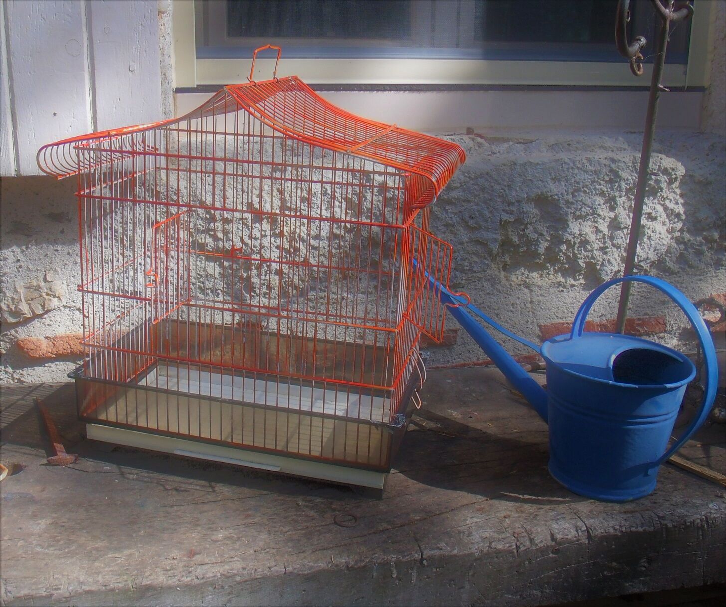 Old red metal birdcage