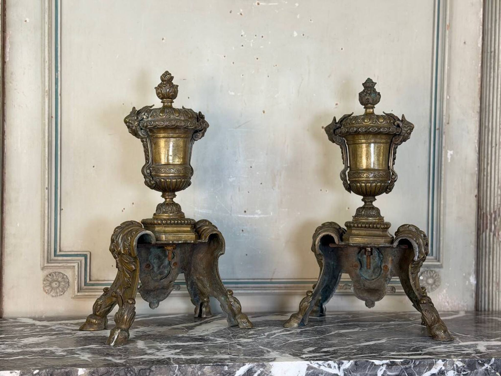Pair of Louis XIV style andirons in bronze after a design by André-Charles Boulle.