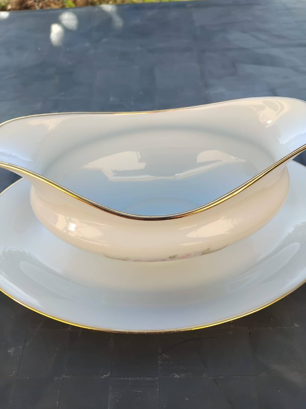 Vintage fine porcelain sauce boat with gold gilding.