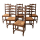 Set of 6 rustic wooden chairs with woven straw.