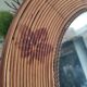 Vintage rattan arch mirror medium honey burnt leaf and metal decoration