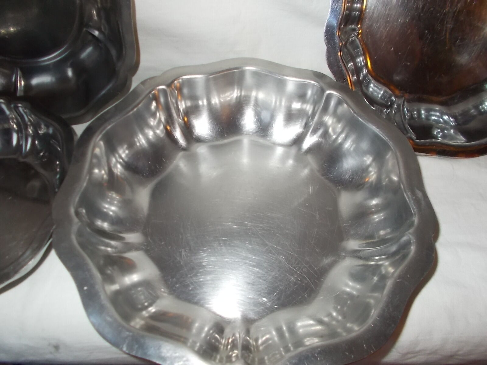 Lot of 4 round hollow stainless steel dishes