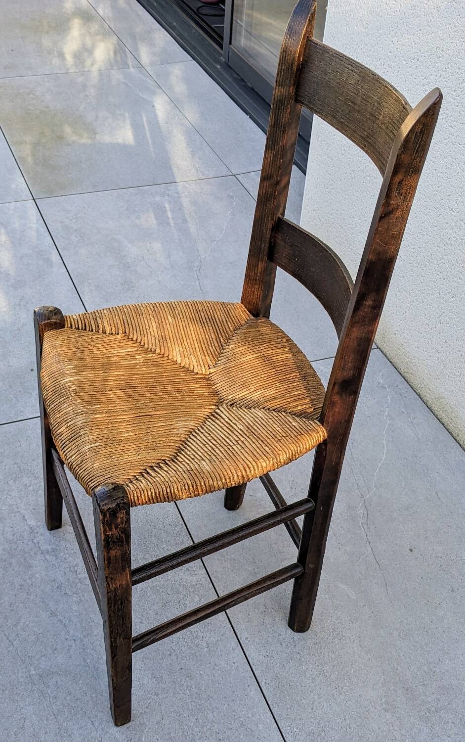4 mismatched wood and straw chairs