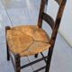 4 mismatched wood and straw chairs