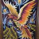 Framed embroidered canvas of a firebird.
