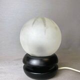 Small black wooden table lamp with frosted glass globe