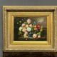 Still life with roses in a beautiful frame on a wooden panel in Flemish style.