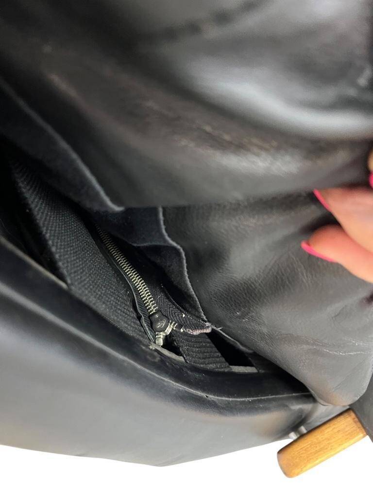 Vintage black leather armchair / Andre Vandenbeuck single seater armchair