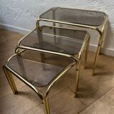 Series of 3 nesting tables in smoked glass & gilded brass