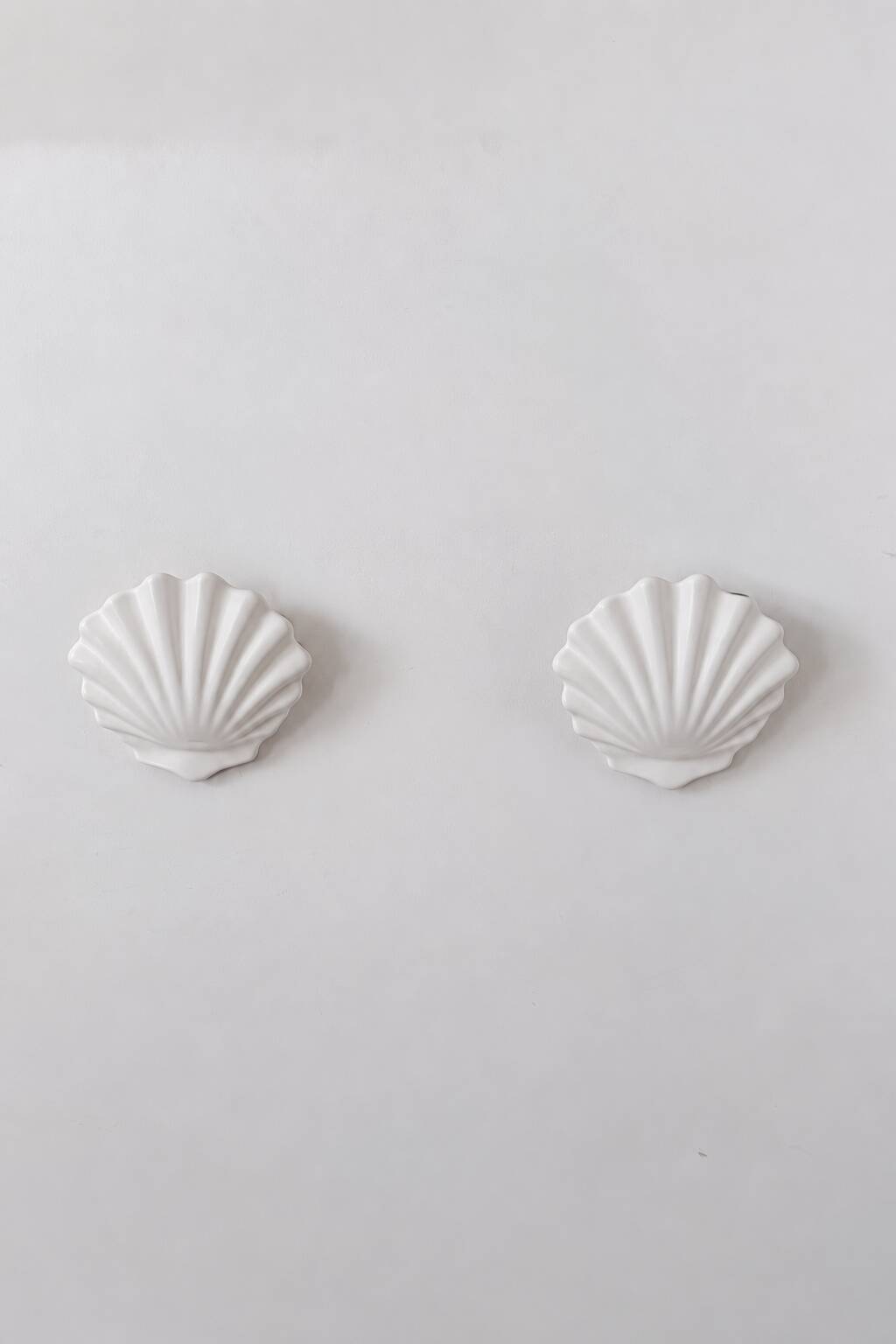Vintage pair of white porcelain wall lights, France 1970.