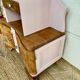 Art Deco bedside table in powder pink painted wood.