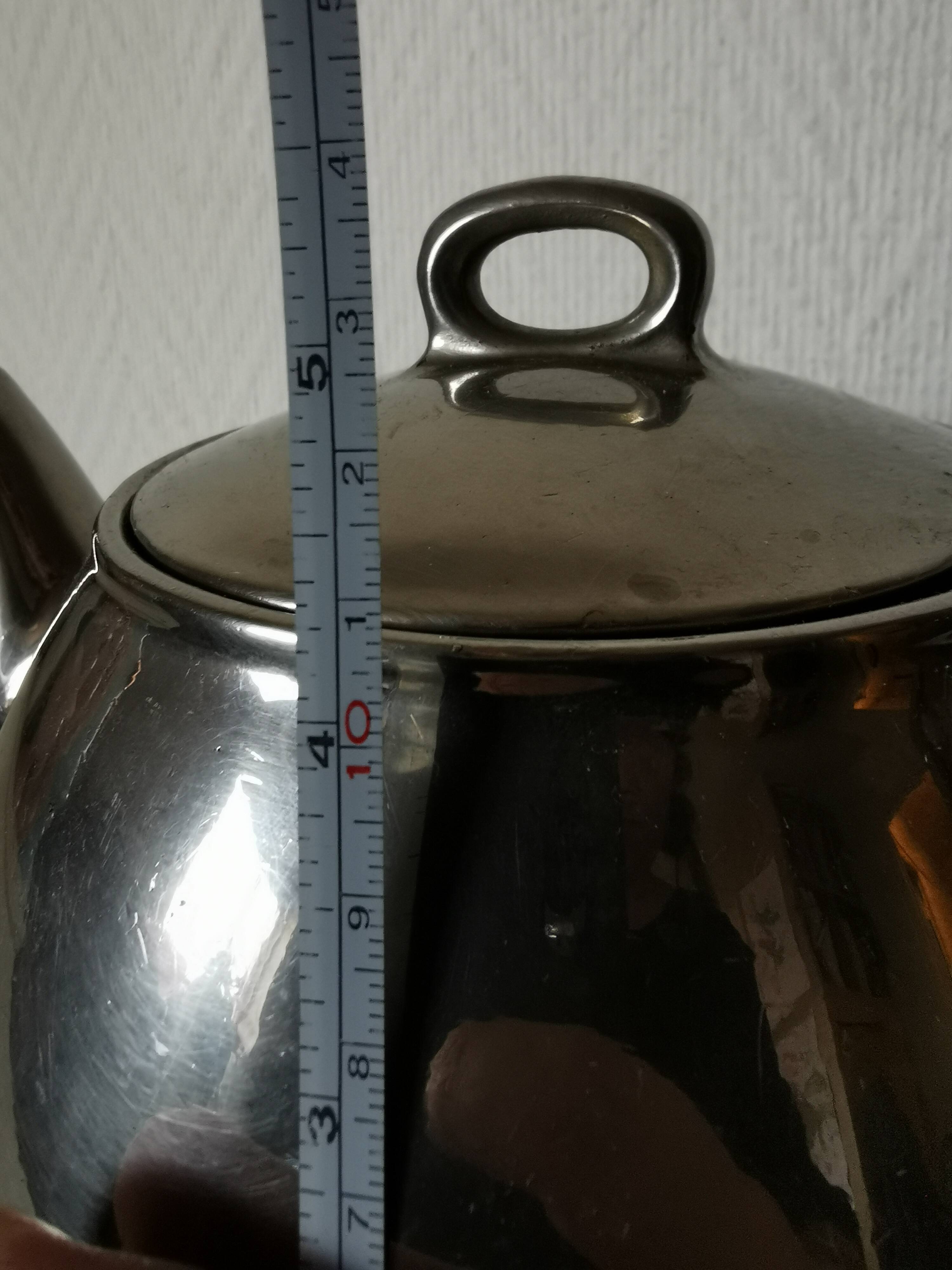 vintage teapot covered with silver metal