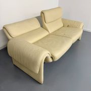 Two-seater designer sofa De Sede DS-2011 in cream leather with adjustable backrest.