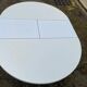 White dining table with a central tulip base, extendable to 100cm.