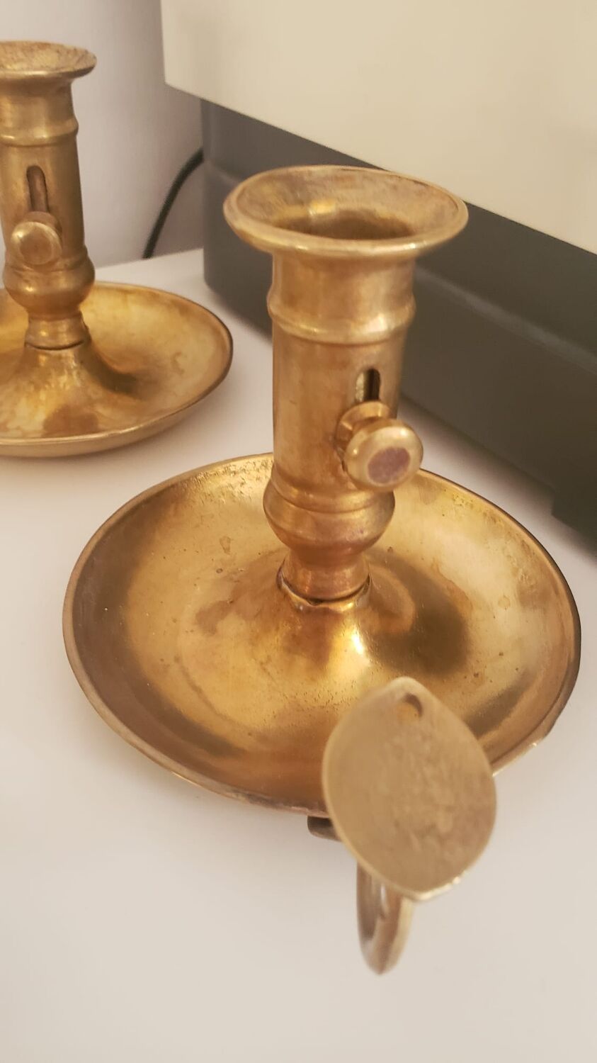 Many candlesticks and a small oil lamp.