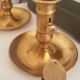 Many candlesticks and a small oil lamp.