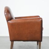Sheepskin art deco design armchair with timeless and warm colours