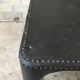 large industrial table in graphite black riveted metal
