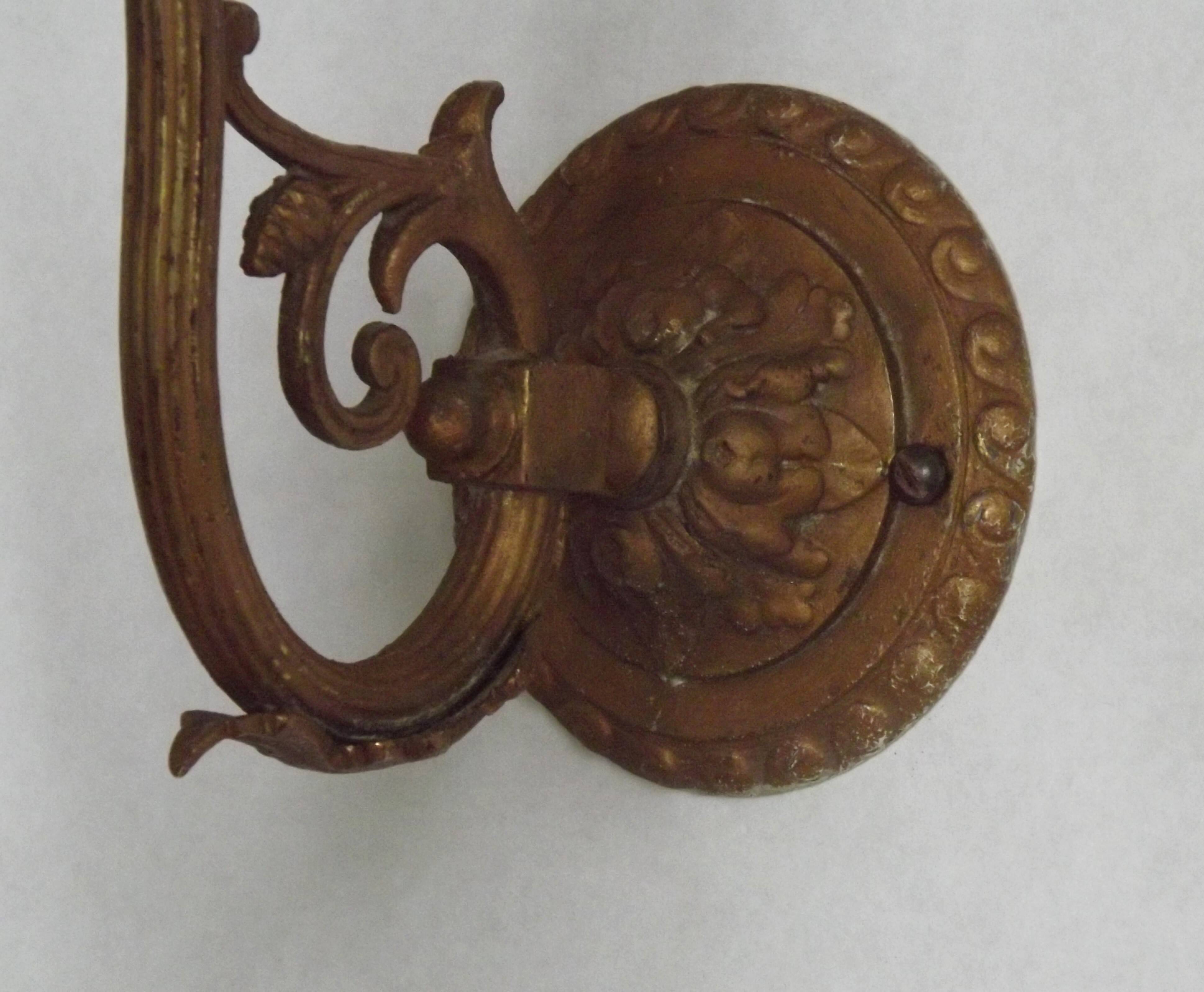 French Art Nouveau wall sconce in bronze with a white and pink glass shade.