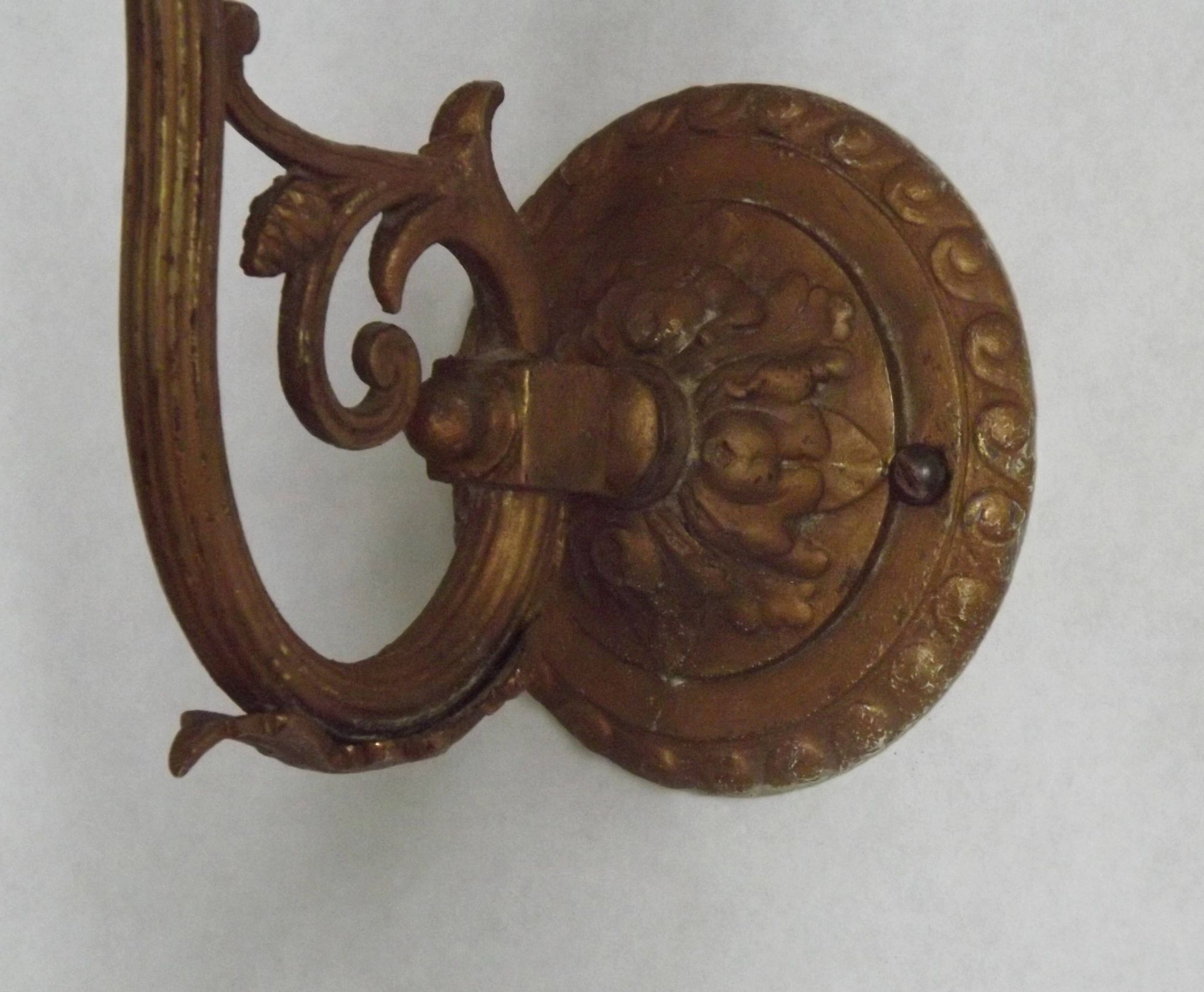 French Art Nouveau wall sconce in bronze with a white and pink glass shade.