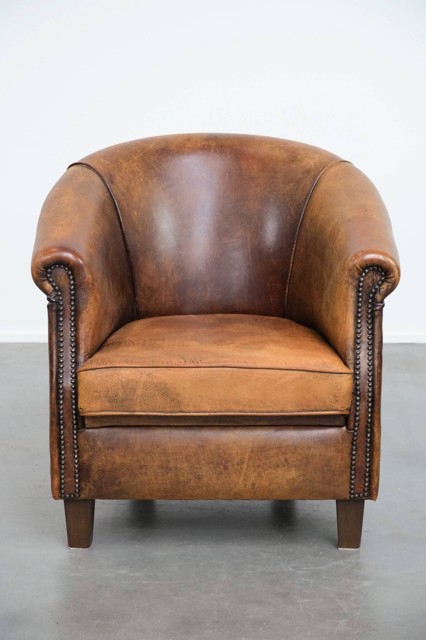 Vintage club chair in sheepskin leather with a characterful look