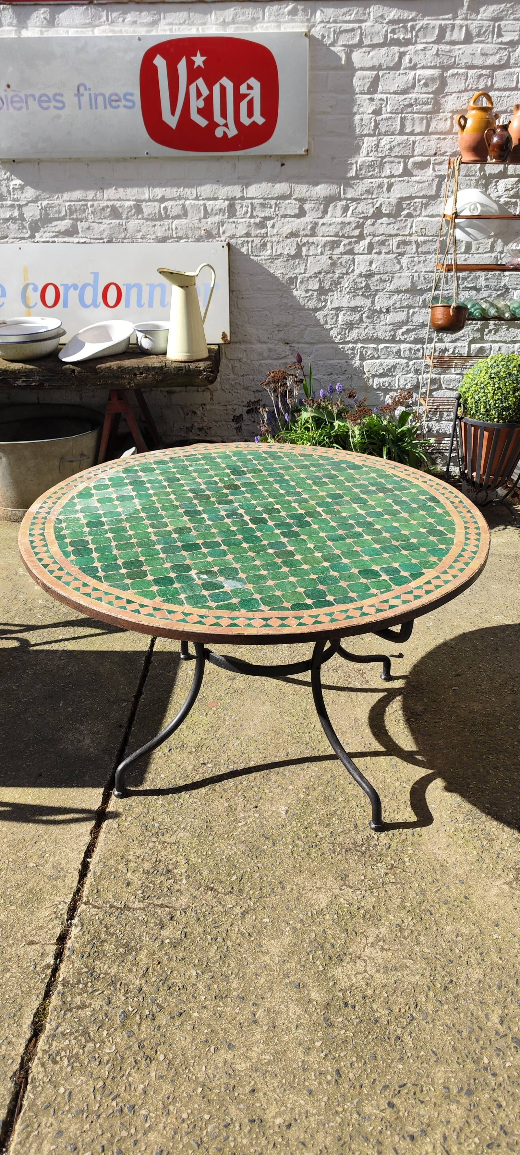 Round zellige table with metal legs and green tile top