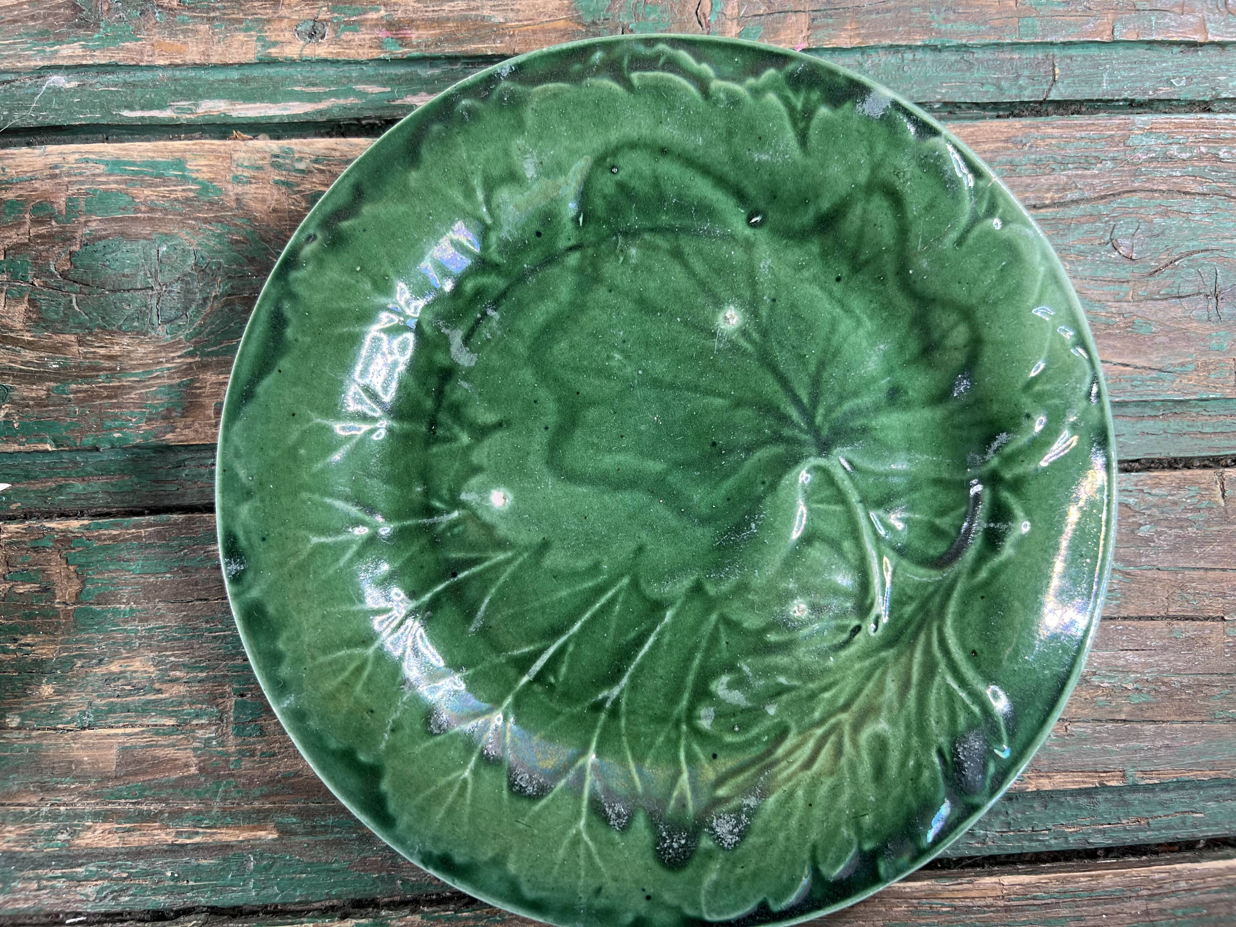 Pair of green slip plates with leaf decoration, 19th century