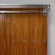 Modernist wall-mounted cloakroom in teak