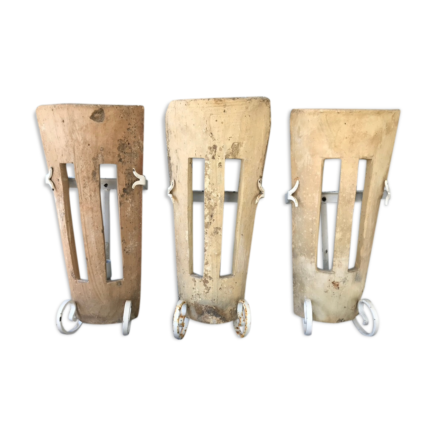 Lot of three terracotta and wrought iron appliques