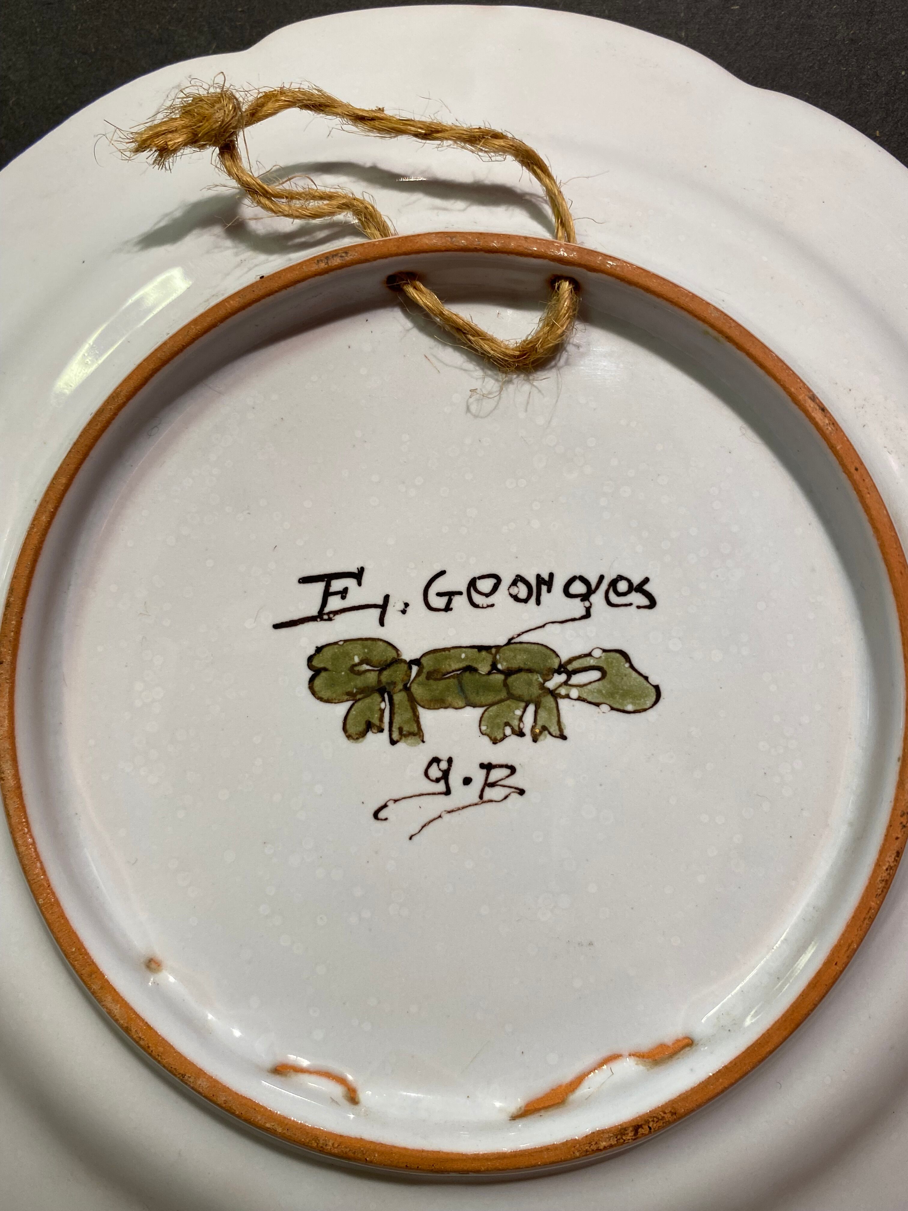 Pair of Nevers earthenware plates signed Georges