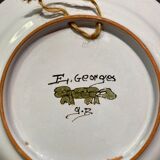 Pair of Nevers earthenware plates signed Georges