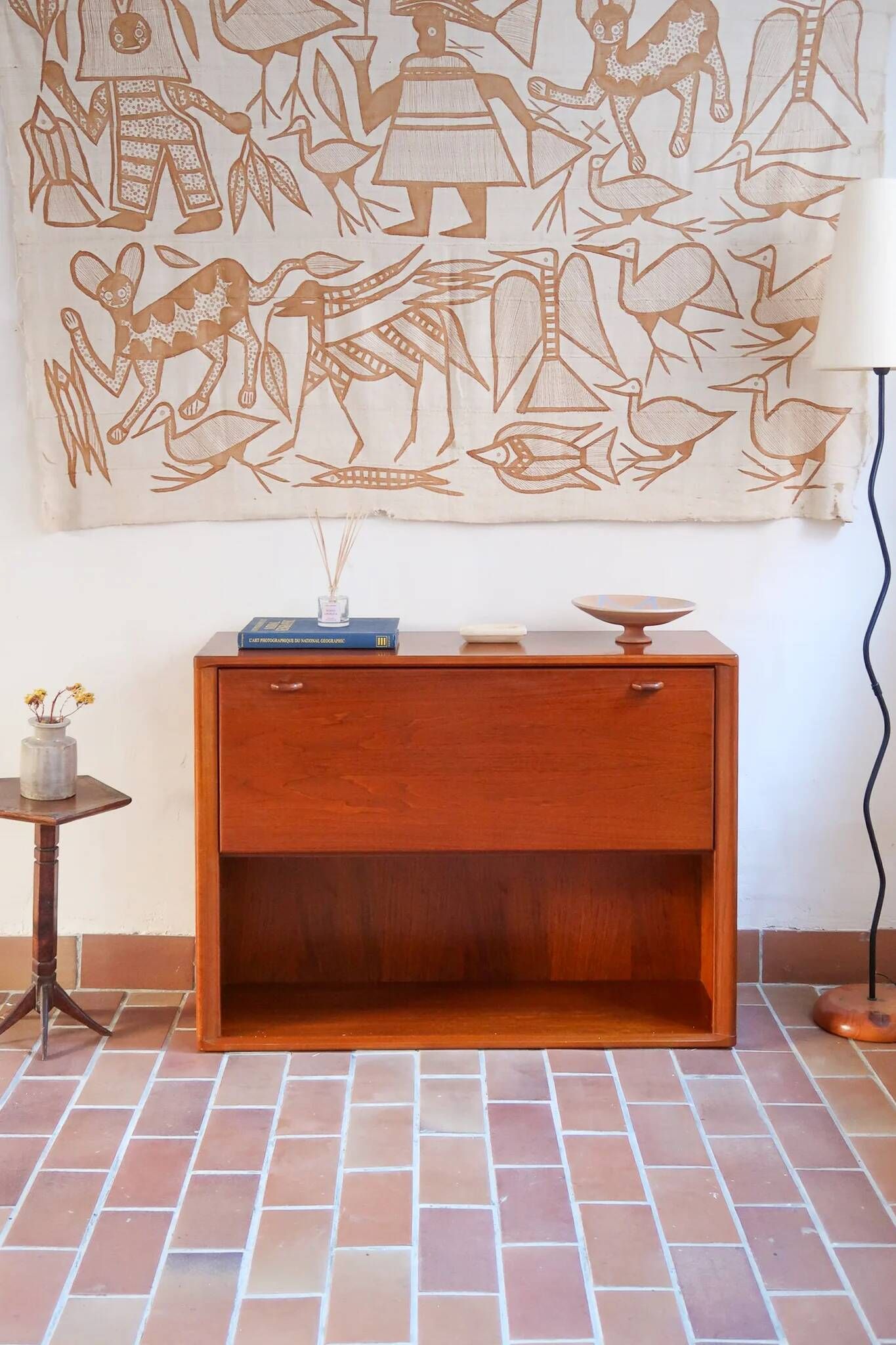 Vintage teak bar cabinet with black glass interior.