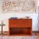 Vintage teak bar cabinet with black glass interior.