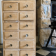 Vintage antique workshop cabinet with 12 drawers in raw wood.