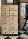 Vintage antique workshop cabinet with 12 drawers in raw wood.
