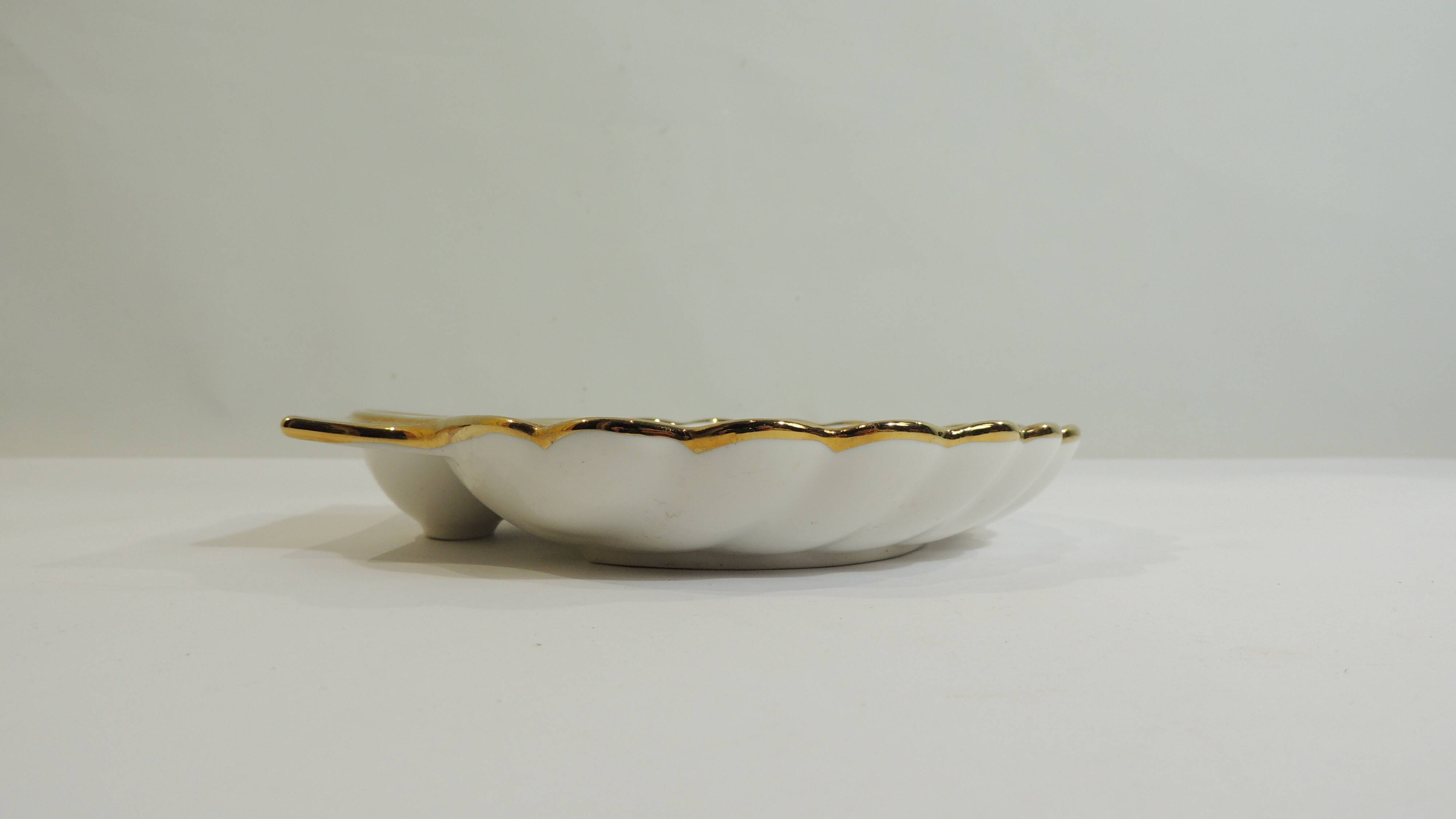 Shell-shaped porcelain pocket bowl from Queen’s Porcelain, with a gold rim.