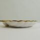 Shell-shaped porcelain pocket bowl from Queen’s Porcelain, with a gold rim.